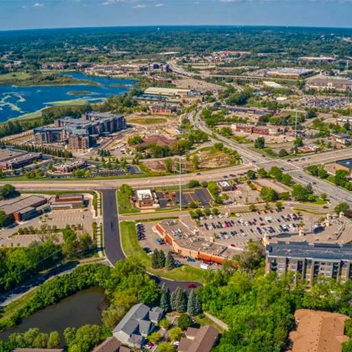 Plymouth, MN – aerial of shopping centers, apartments, and wetlands along the highway
